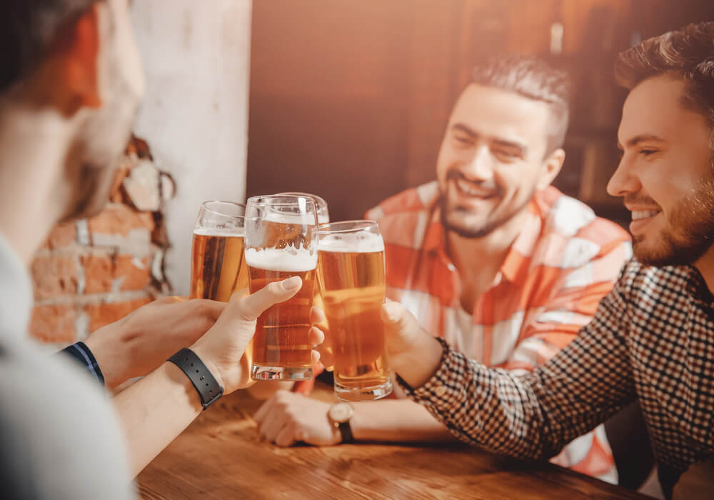 Men celebrating and drinking beer on stag weekend