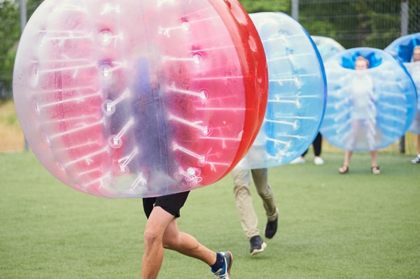 Men playing bubble football on stag weekend