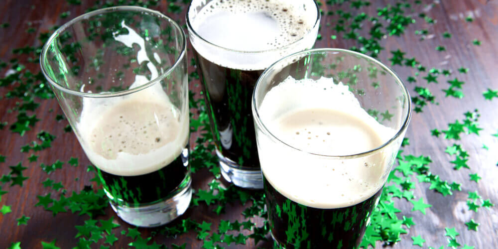 Pints of Guinness with green stars on table