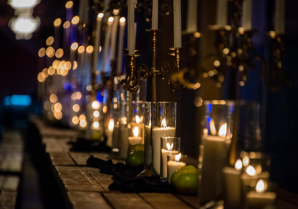 Long wooden banquet table with candles 