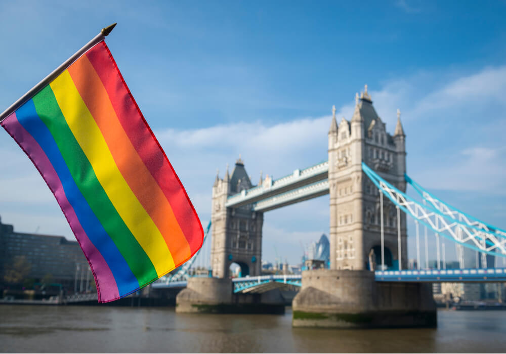 Pride flag in front of London Skyline at Tower Bridge on a summer day