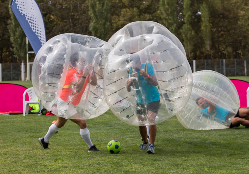 Men playing bubble football on stag weekend