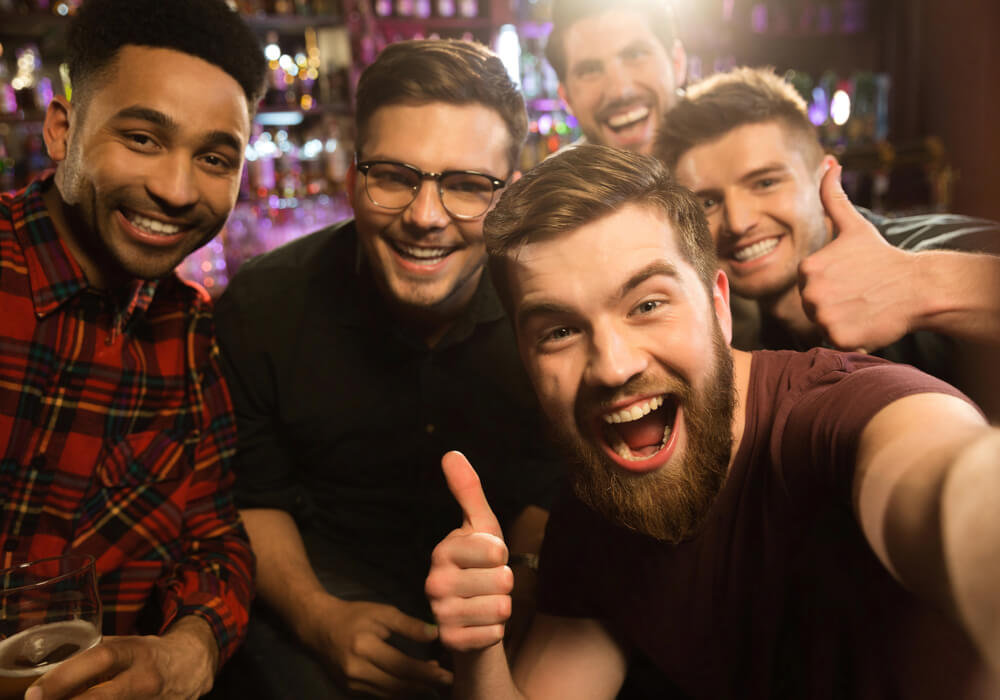 Group of men smiling and celebrating