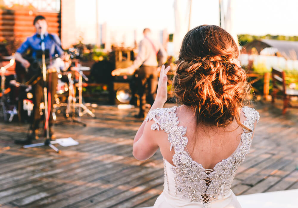 Bride clapping along to wedding band